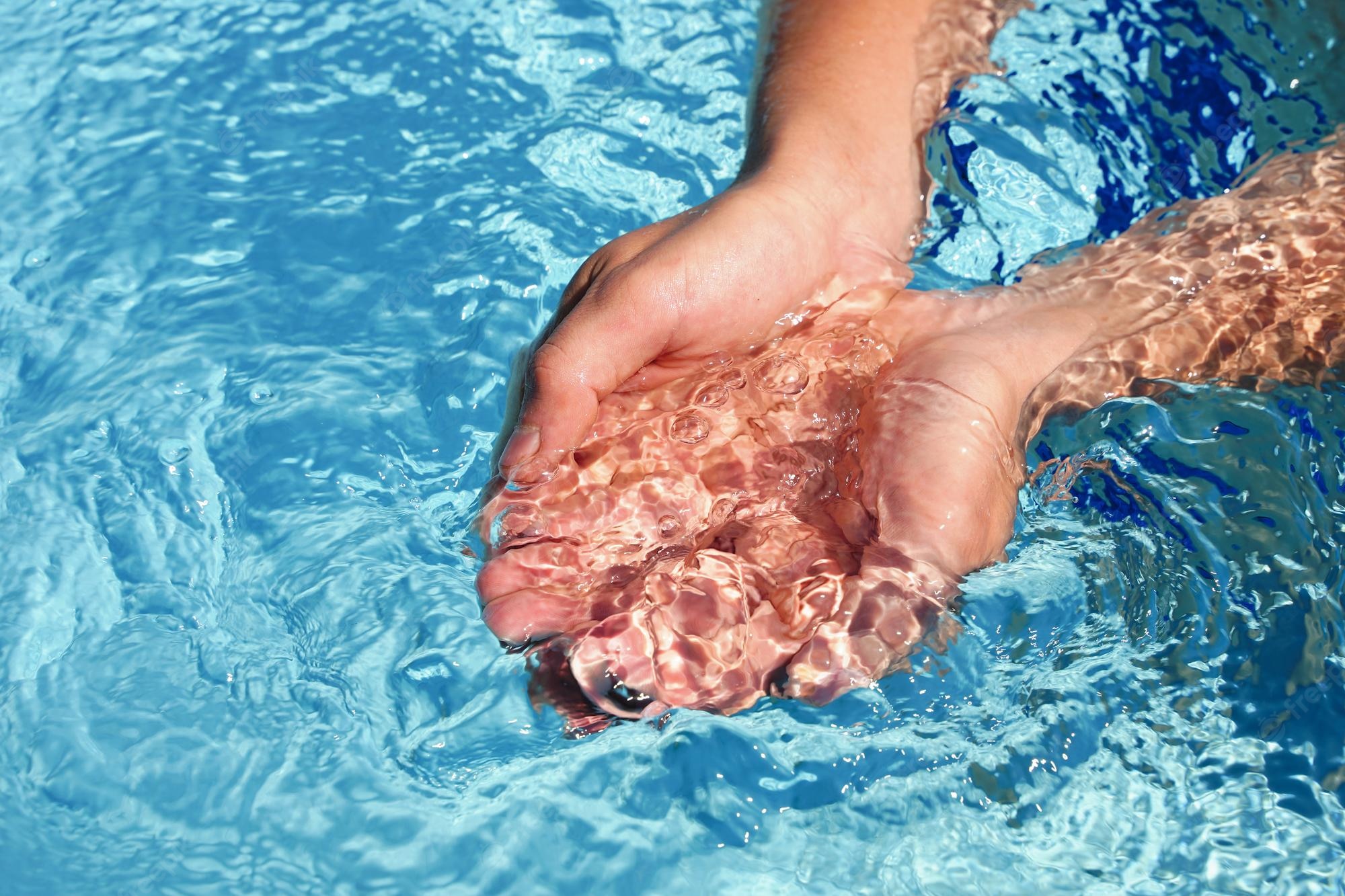hands-cupped-together-submerged-clean-clear-blue-water-swimming-pool_373520-2848